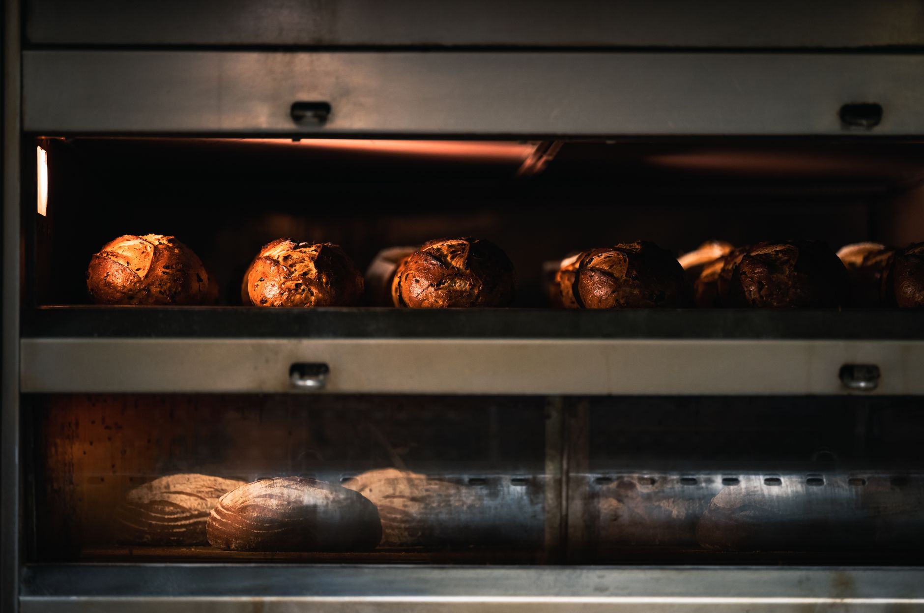 Warm artisan bread being baked to perfection in a professional industrial oven.